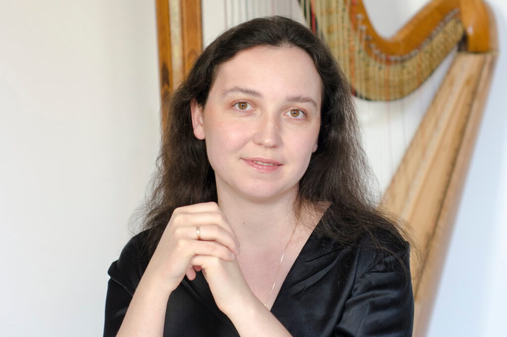 Ionella Marinutsa, professional harpist and music educator, pictured with her concert harp